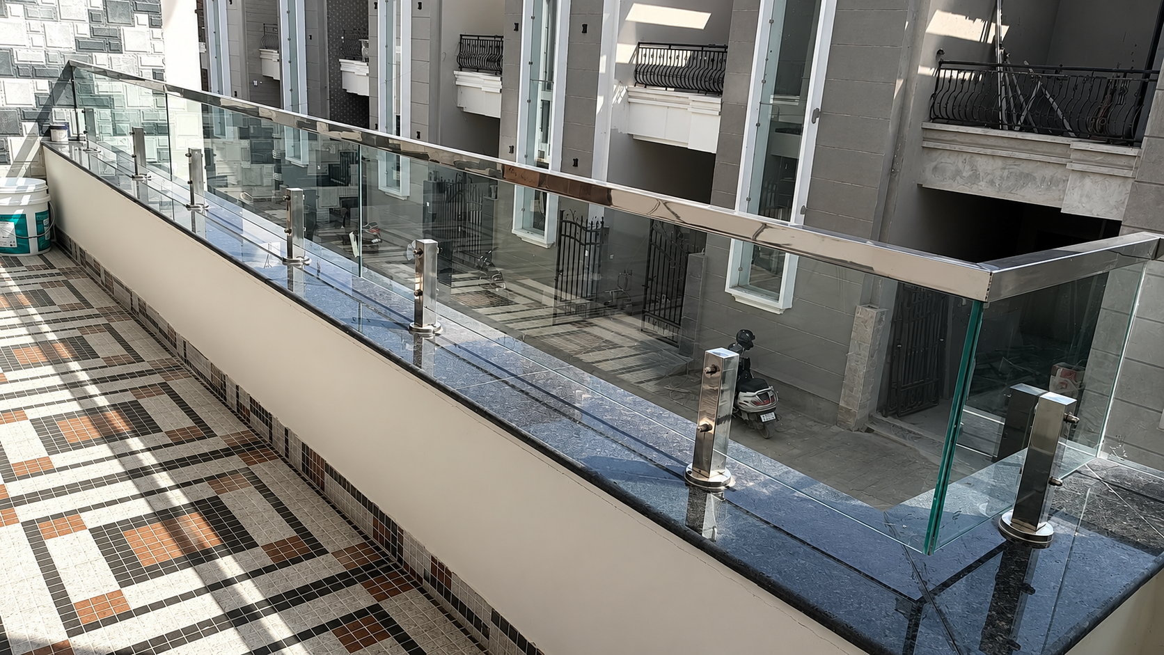 Stainless steel and toughened glass balcony railing by Lotey Metalcrafts