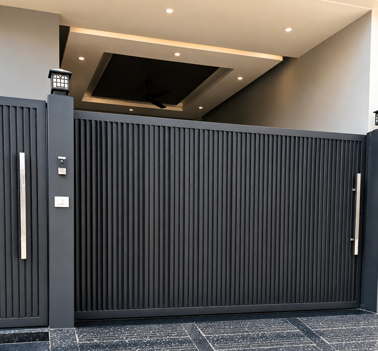 Matte charcoal grey automated vertical slatted gate by Lotey Metalcrafts