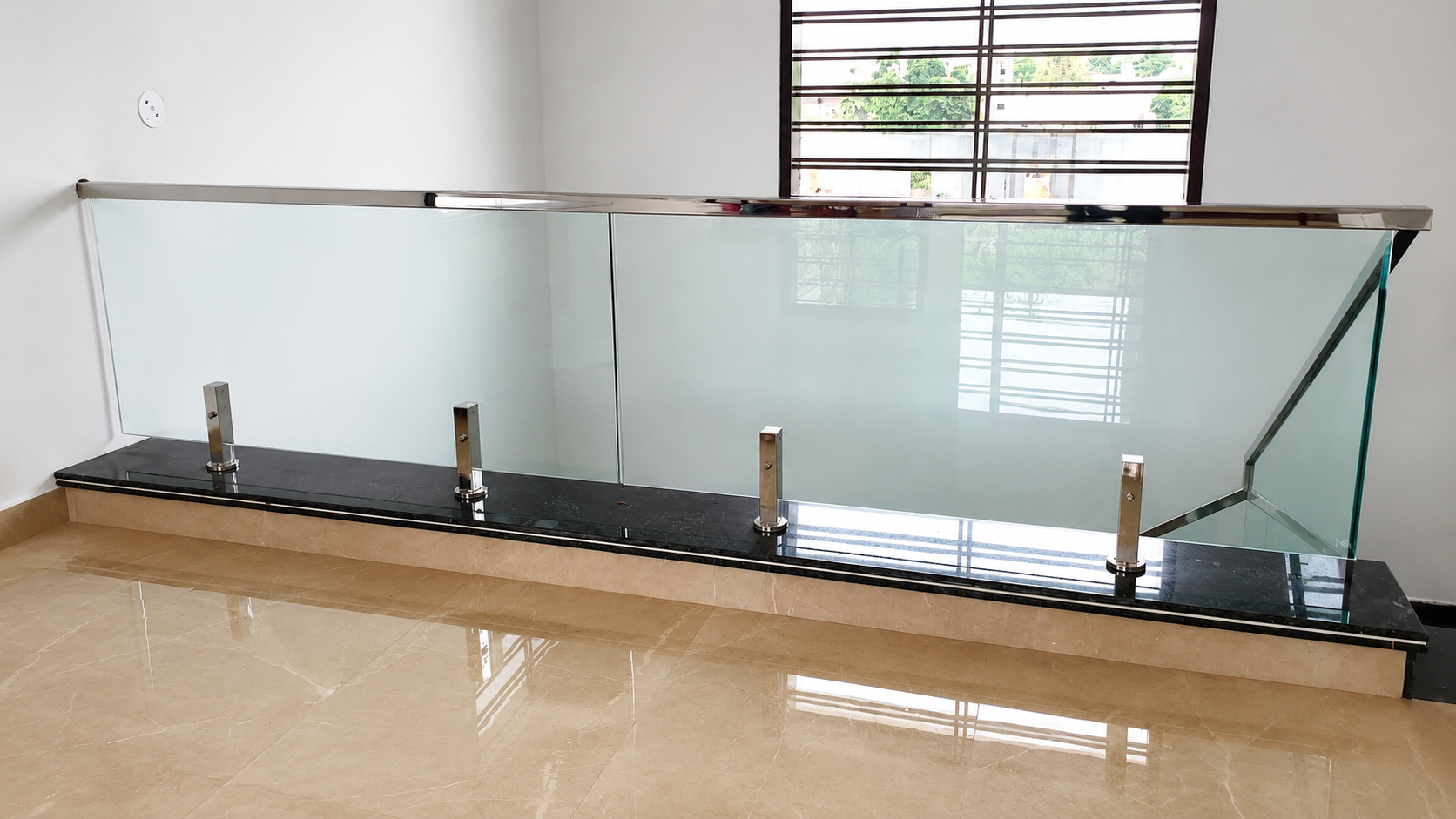 Frosted glass interior mezzanine balustrade with stainless steel cap by Lotey Metalcrafts