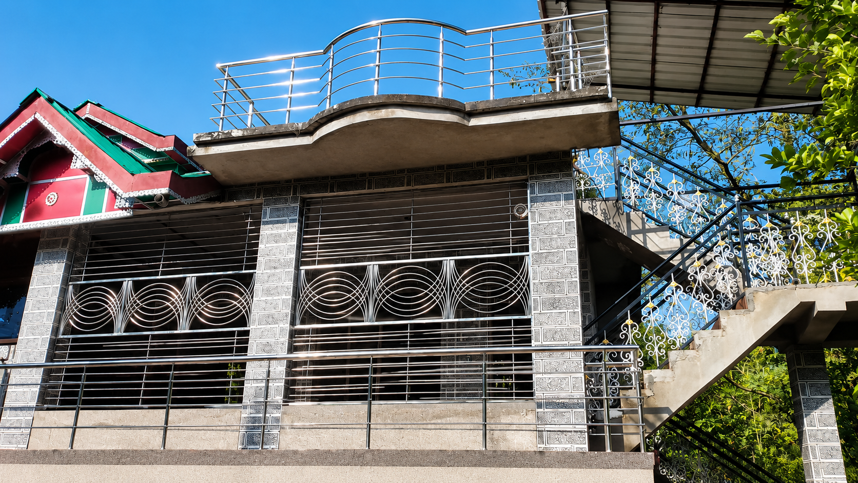 Stainless steel security window grills and curved balcony railing by Lotey Metalcrafts