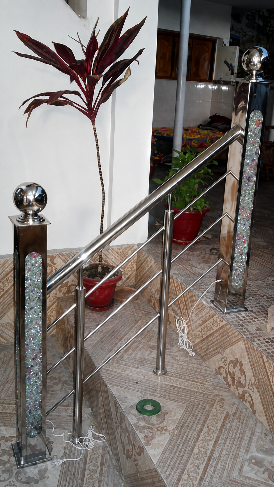 Stainless steel staircase with crystal filled designer newel post by Lotey Metalcrafts
