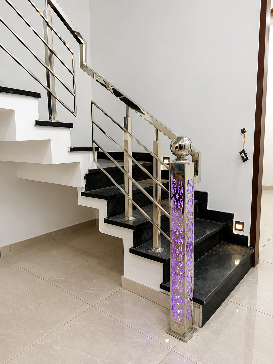 Staircase with backlit LED laser cut stainless steel newel post by Lotey Metalcrafts