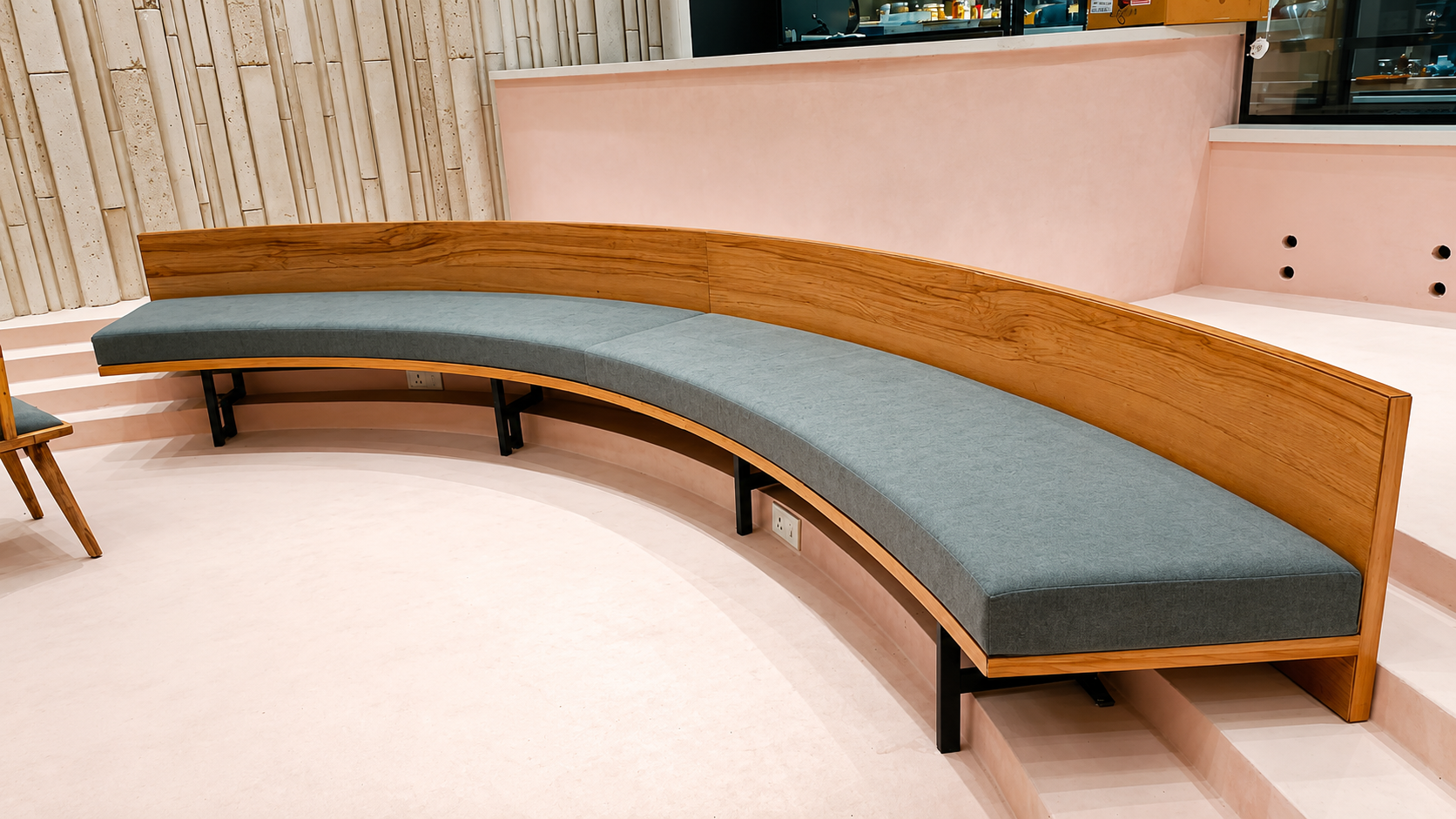 S-curved wooden banquette seating on metal base by Lotey Metalcrafts